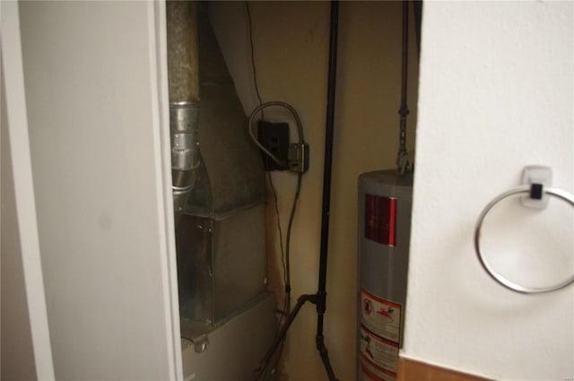 utility room featuring gas water heater