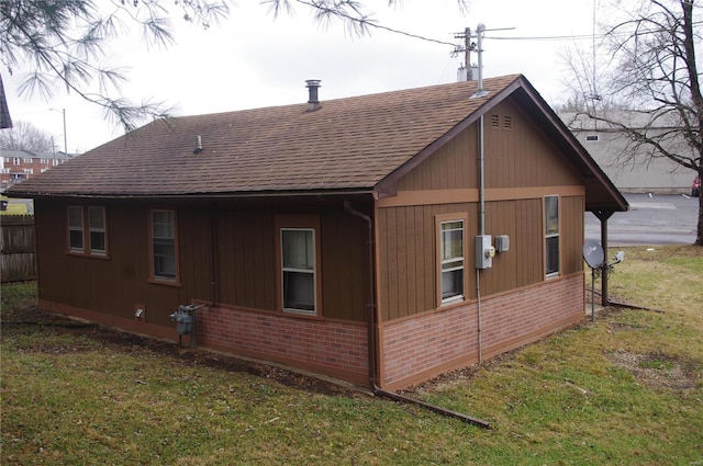 view of side of home featuring a yard