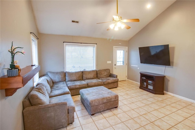 living room with ceiling fan, light tile patterned floors, and vaulted ceiling