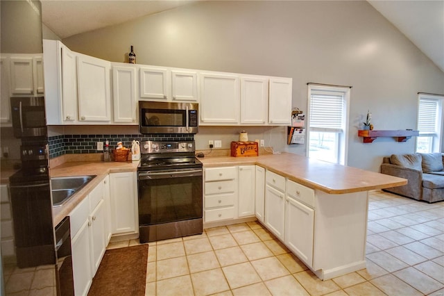 kitchen with white cabinets, kitchen peninsula, range with electric cooktop, and light tile patterned floors