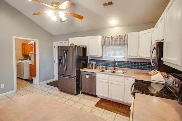 kitchen featuring white cabinetry, sink, lofted ceiling, light tile patterned flooring, and appliances with stainless steel finishes