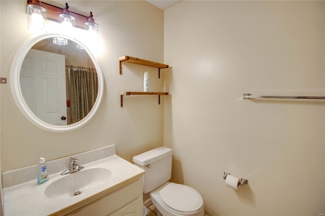 bathroom with vanity, toilet, and walk in shower