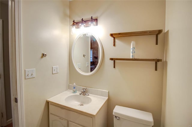 bathroom featuring vanity and toilet