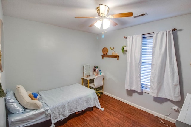 bedroom with ceiling fan and wood-type flooring