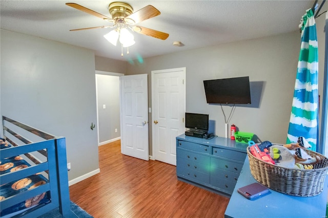 bedroom featuring hardwood / wood-style floors and ceiling fan