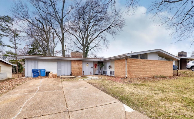 ranch-style home featuring a garage and a front yard