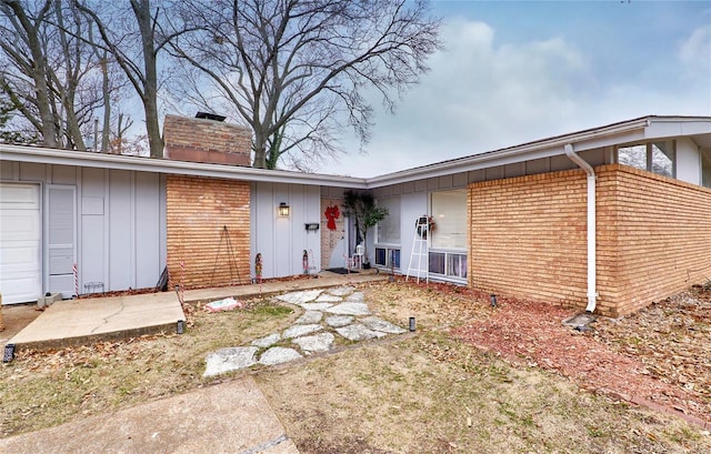 back of house featuring a garage