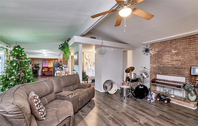 living room featuring ceiling fan, wood-type flooring, and vaulted ceiling