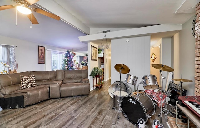 living room with hardwood / wood-style floors, lofted ceiling with beams, and ceiling fan