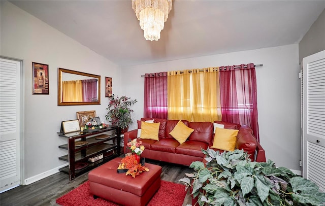 living room featuring dark hardwood / wood-style floors, an inviting chandelier, and lofted ceiling