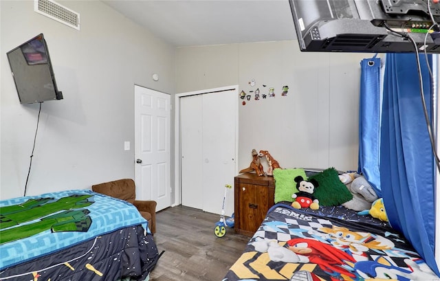 bedroom with a closet and dark hardwood / wood-style flooring