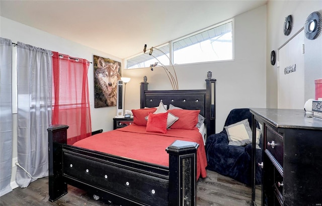 bedroom featuring hardwood / wood-style flooring and vaulted ceiling