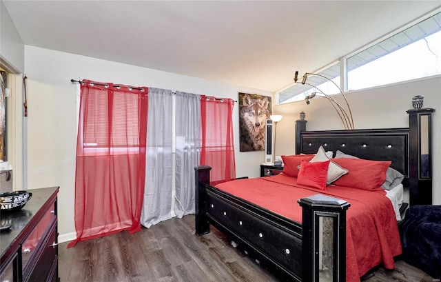 bedroom with wood-type flooring and lofted ceiling