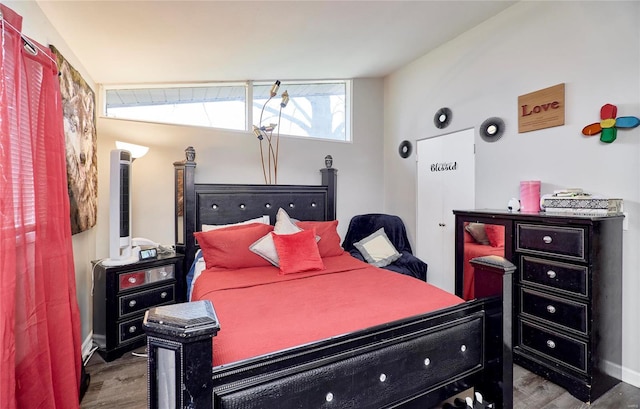 bedroom featuring hardwood / wood-style flooring and vaulted ceiling