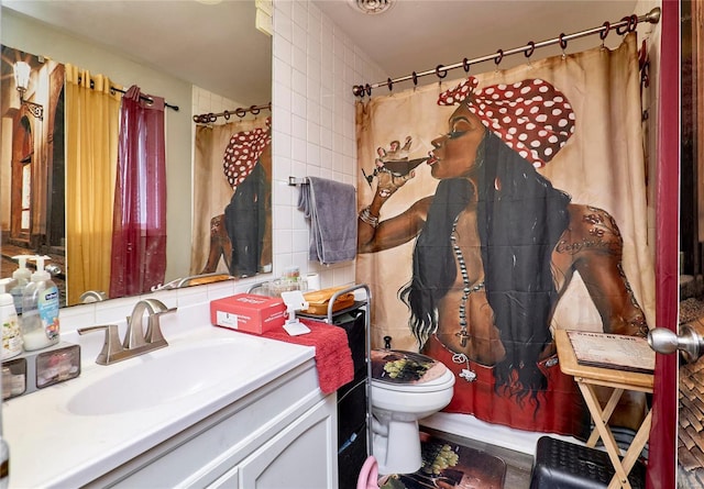 bathroom featuring vanity and toilet