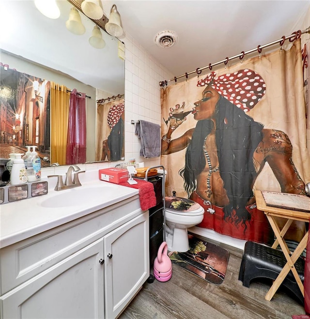 bathroom featuring hardwood / wood-style flooring, vanity, toilet, and a shower with shower curtain