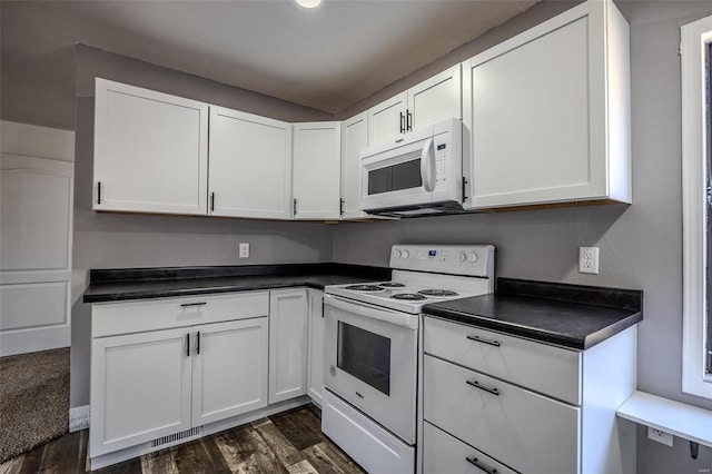 kitchen with dark hardwood / wood-style floors, white cabinetry, and white appliances