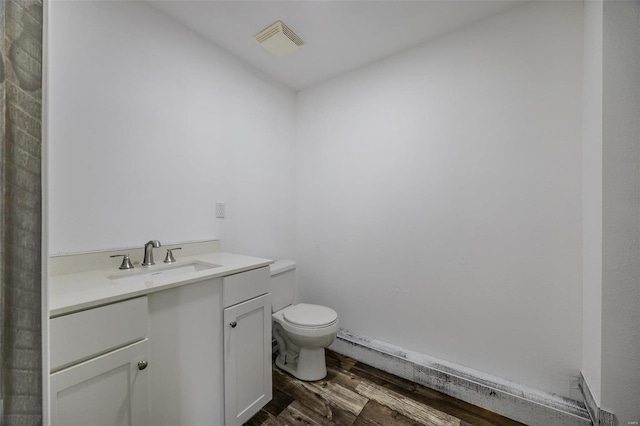 bathroom featuring hardwood / wood-style floors, vanity, and toilet