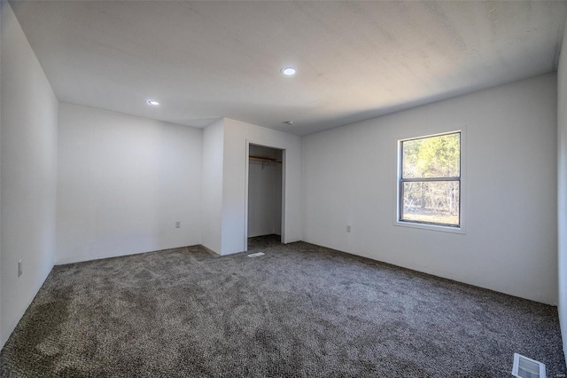 unfurnished bedroom featuring carpet flooring and a closet