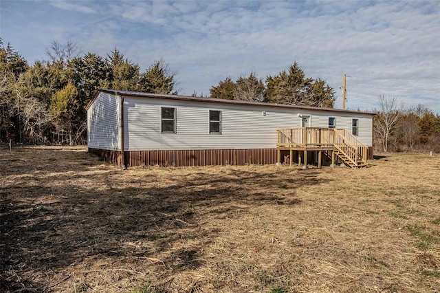 rear view of house with a wooden deck