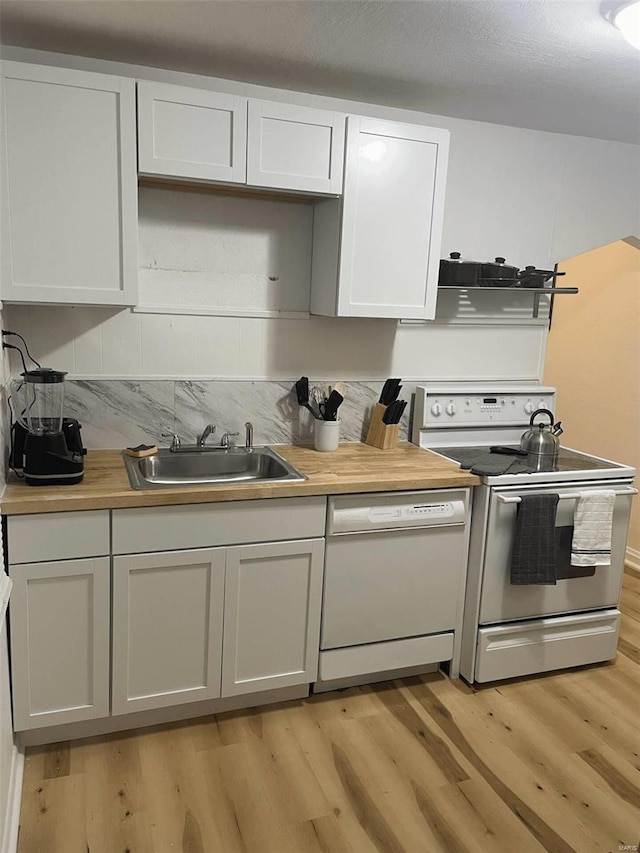 kitchen with electric range, dishwasher, sink, light hardwood / wood-style flooring, and white cabinets