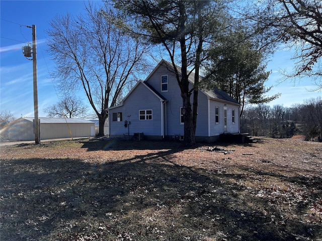 view of home's exterior with an outbuilding and cooling unit