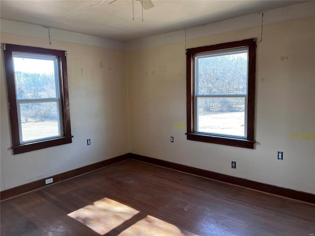 spare room featuring ceiling fan and dark hardwood / wood-style flooring