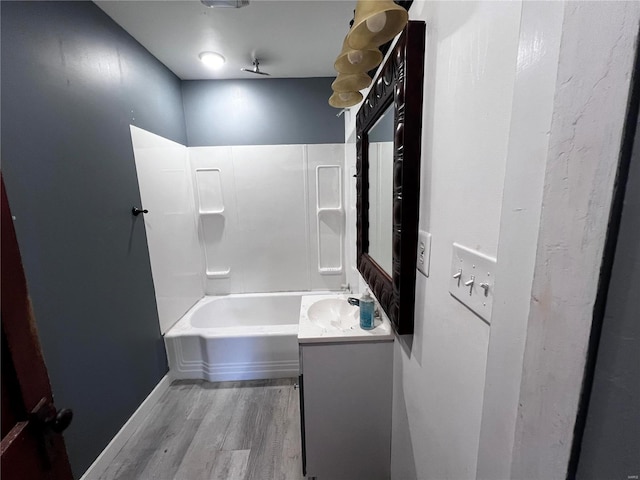 bathroom with shower / bathing tub combination, vanity, and hardwood / wood-style flooring