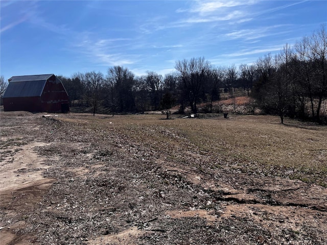 view of yard featuring a rural view and an outdoor structure