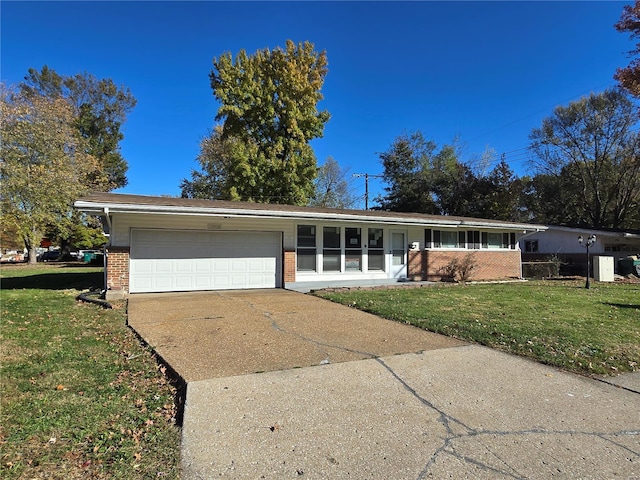 ranch-style house featuring a garage and a front yard