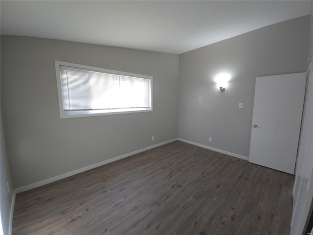 empty room with dark hardwood / wood-style flooring