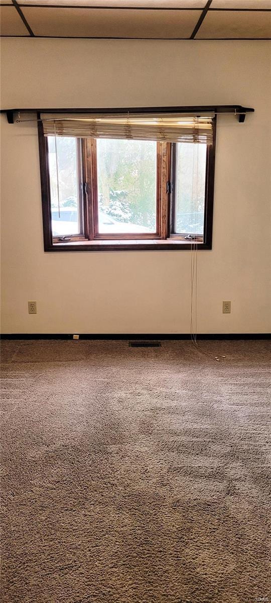 unfurnished room with carpet flooring and plenty of natural light