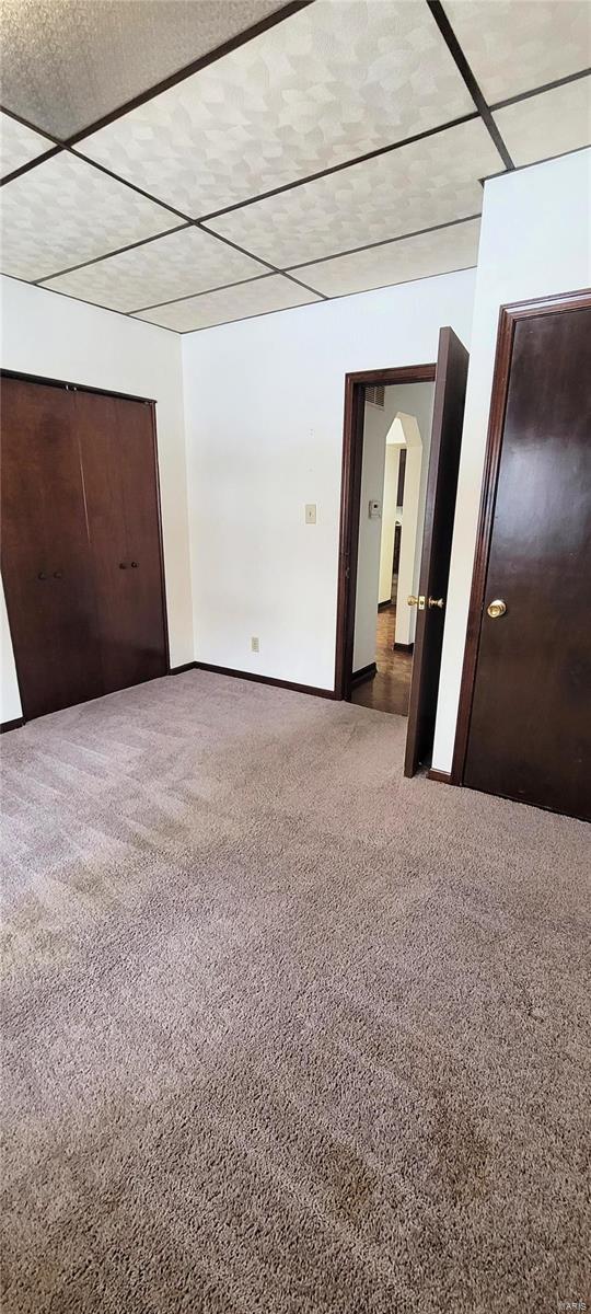 unfurnished bedroom featuring carpet and a closet