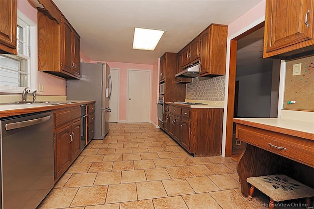 kitchen with decorative backsplash, sink, and stainless steel appliances