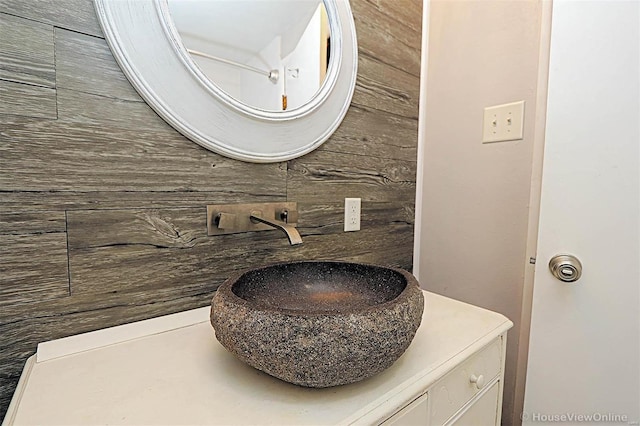 bathroom with wooden walls and vanity