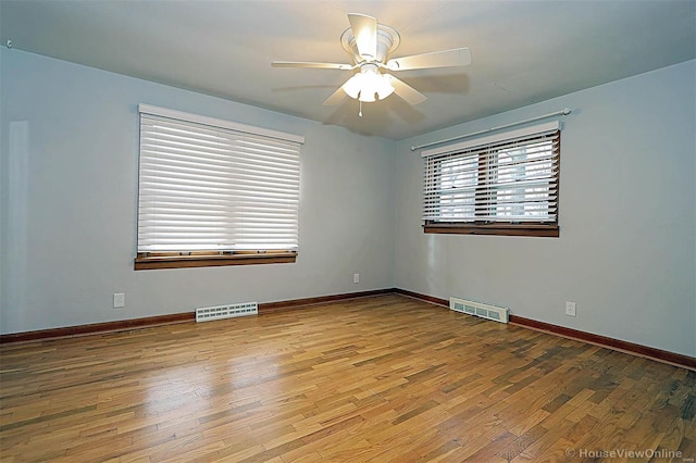 empty room with light wood-type flooring and ceiling fan