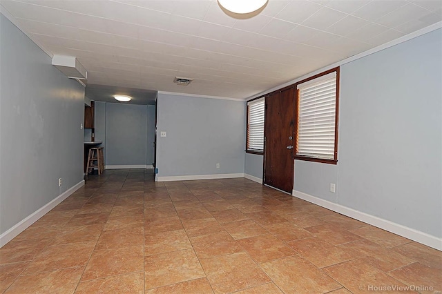 unfurnished room featuring crown molding