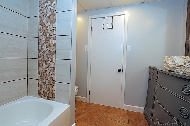 bathroom with vanity, toilet, and a bathing tub