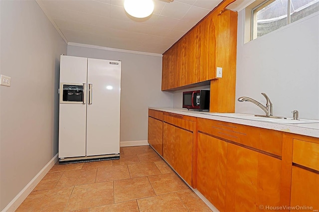 kitchen featuring white refrigerator with ice dispenser and sink