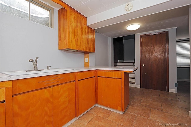 kitchen featuring kitchen peninsula and sink