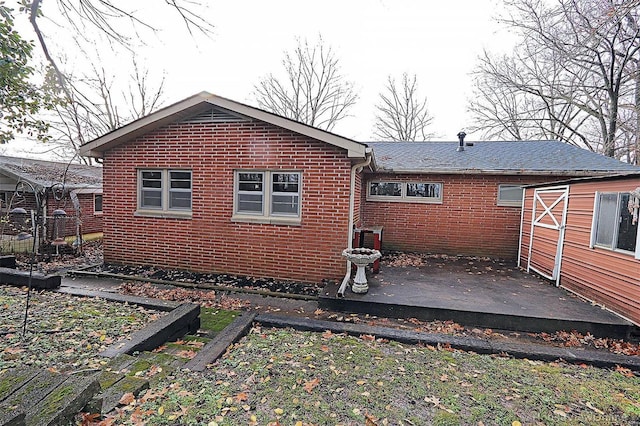 back of property featuring a wooden deck