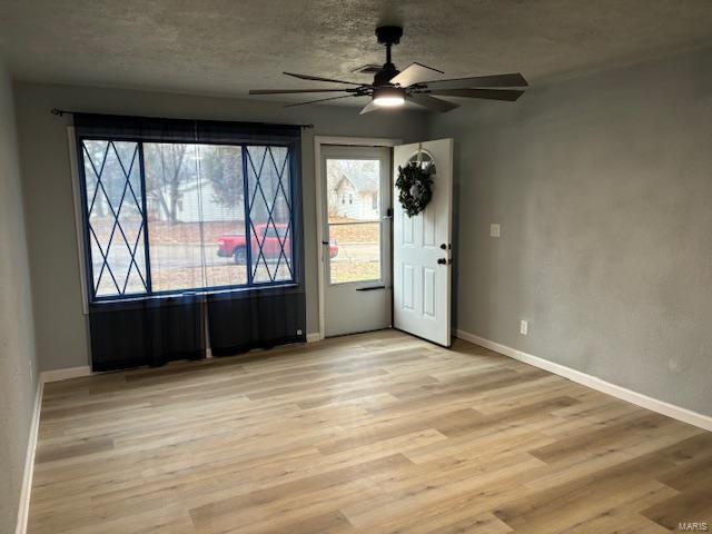 unfurnished room featuring light hardwood / wood-style floors and ceiling fan