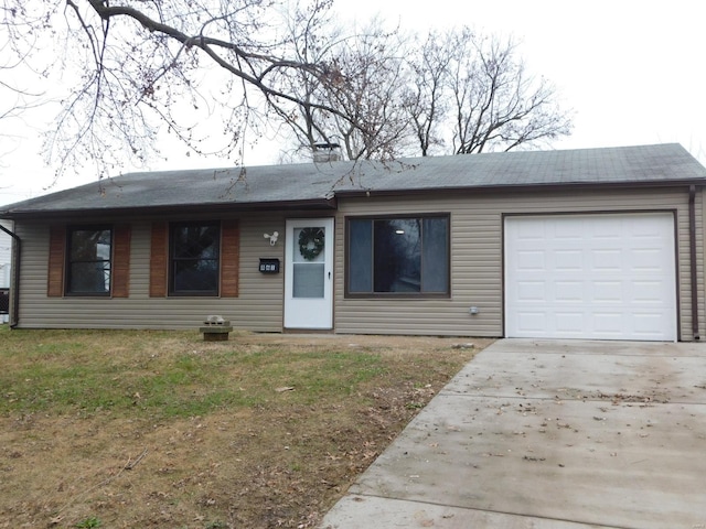 ranch-style home featuring a garage and a front yard