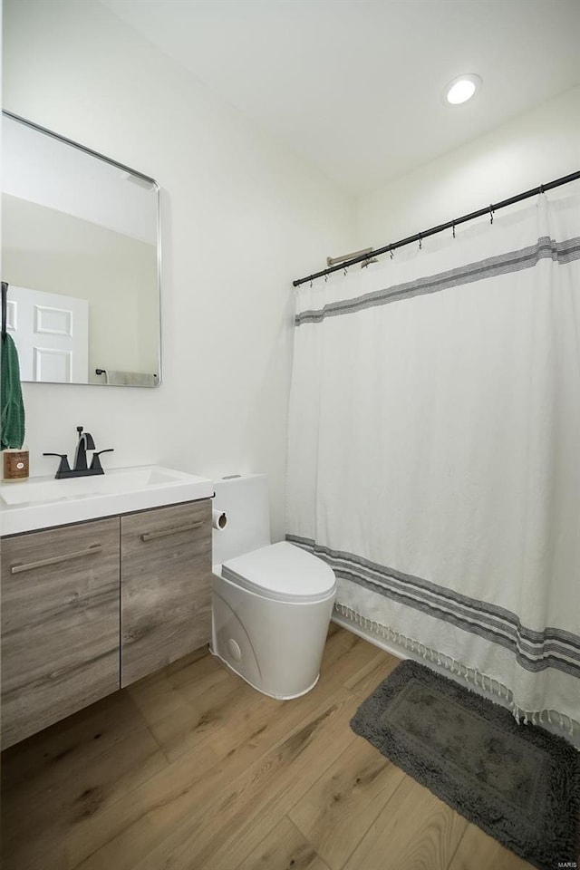 bathroom featuring vanity, toilet, and wood-type flooring