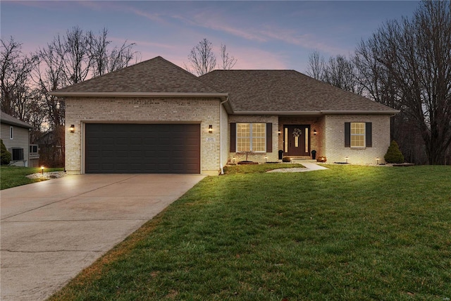 view of front facade featuring a lawn and a garage