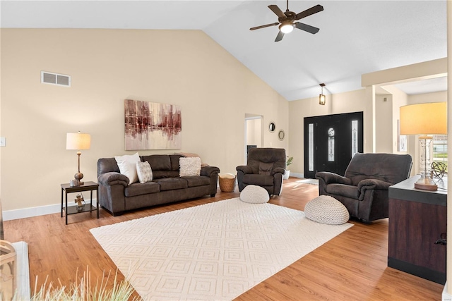 living room with light hardwood / wood-style floors, high vaulted ceiling, and ceiling fan