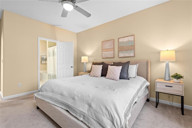 bedroom featuring ensuite bathroom, ceiling fan, and light colored carpet