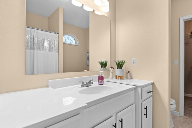 bathroom featuring tile patterned flooring, vanity, and toilet