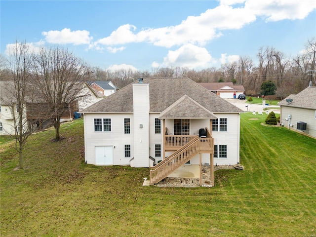 back of property featuring central AC, a deck, and a lawn