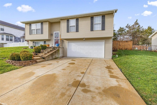 split foyer home with a garage and a front lawn